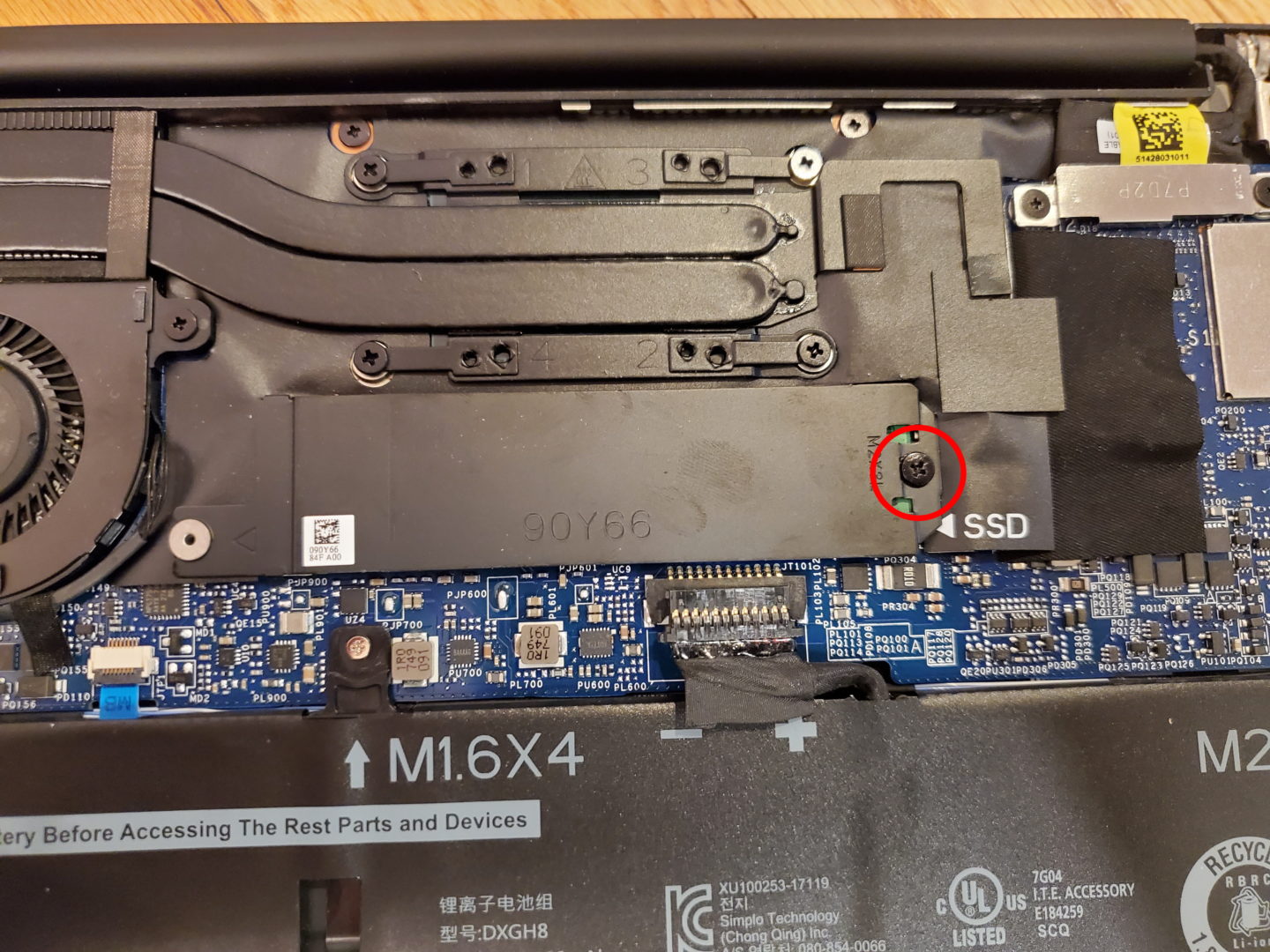 closeup of the screw holding the SSD cover and SSD itself