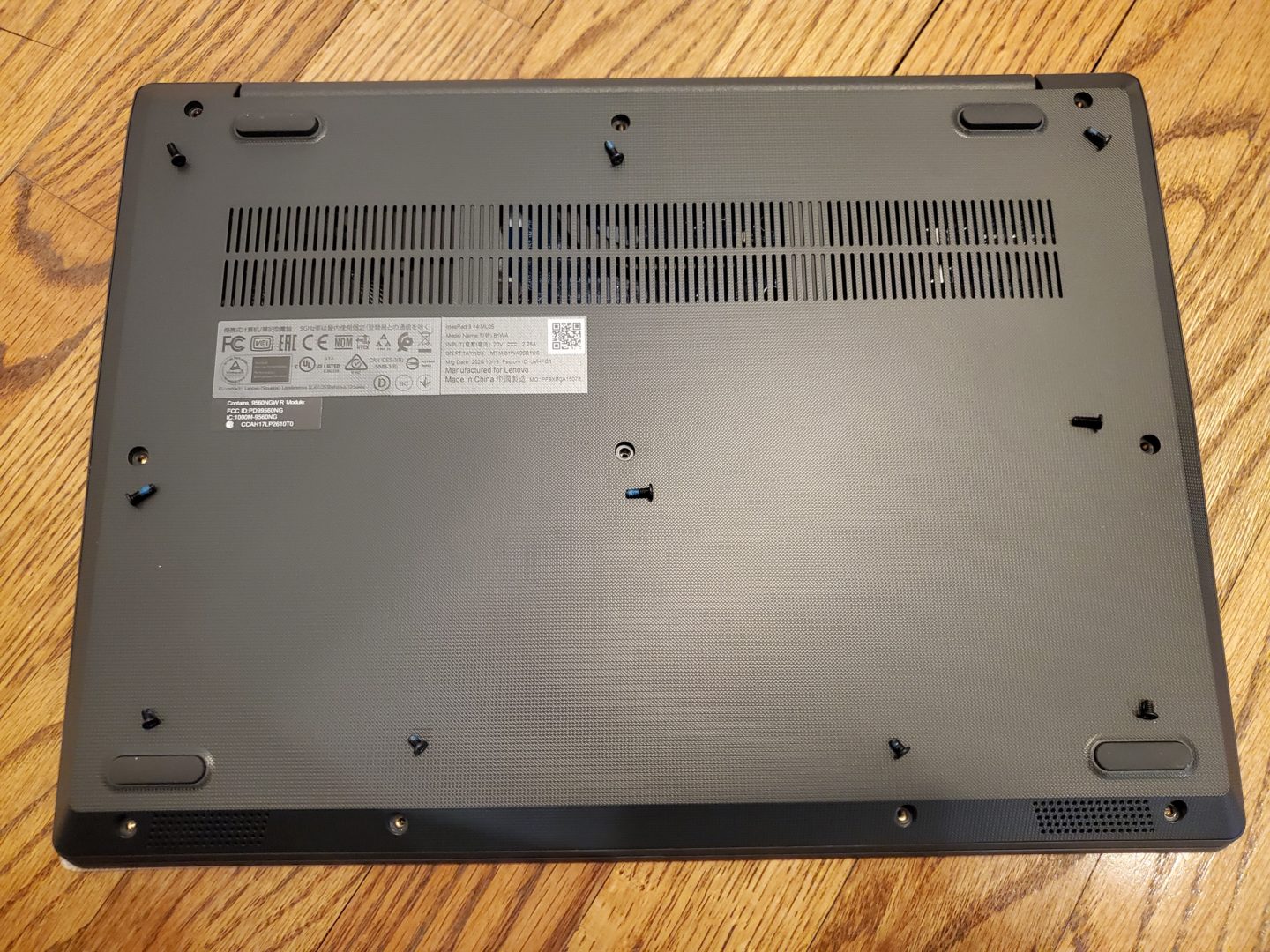 photo of the screws removed from the bottom cover of the ideapad 3 14 laptop.  the first step in how to upgrade a lenovo ideapad 3 14 laptop