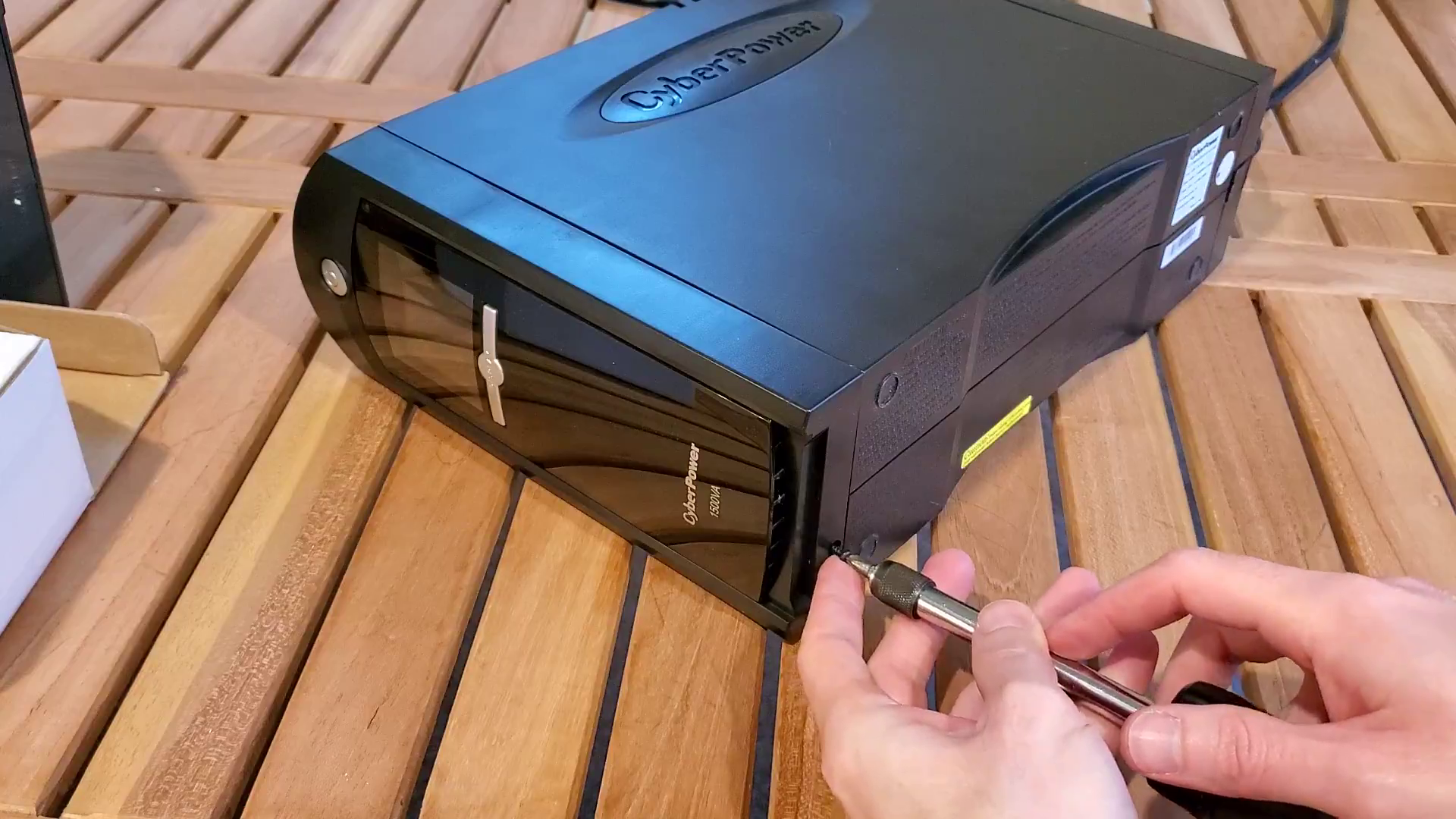 placing the screw back into the UPS, part of the How to Replace a CyberPower 1500AV UPS Battery article