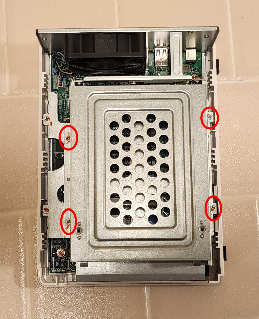 the four screws holding the drive cage of the ts-215