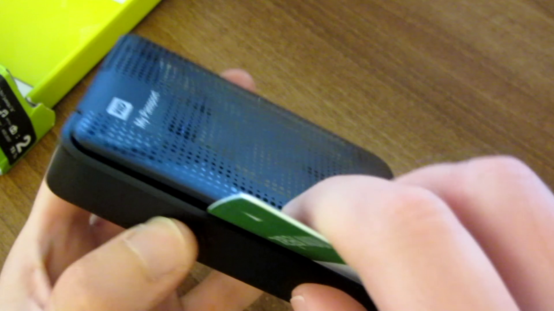 showing a credit card belind slid down the edge of the case, part of showing how to Dismantle a Western Digital My Passport Drive